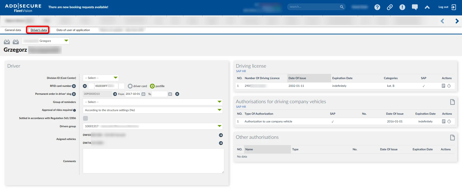 Driver profile page for Grzegorz showing driver information form on the left with RFID card number, permanent order details, reminders group, and assigned vehicles DW10 and DW7A. Right side displays driving license information including license number 2905 issued 2002-01-11 with indefinite expiration, and authorizations for driving company vehicles with authorization to use company vehicle issued 2016-01-01. Other authorizations section shows no data.