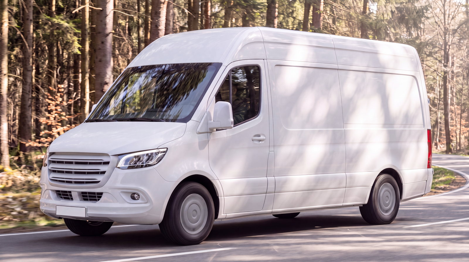 White service van on its way to a callout along a forest road